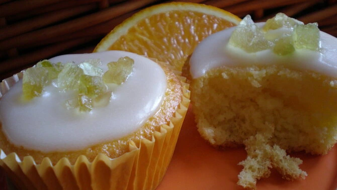 Lemon muffins with icing and orange slice