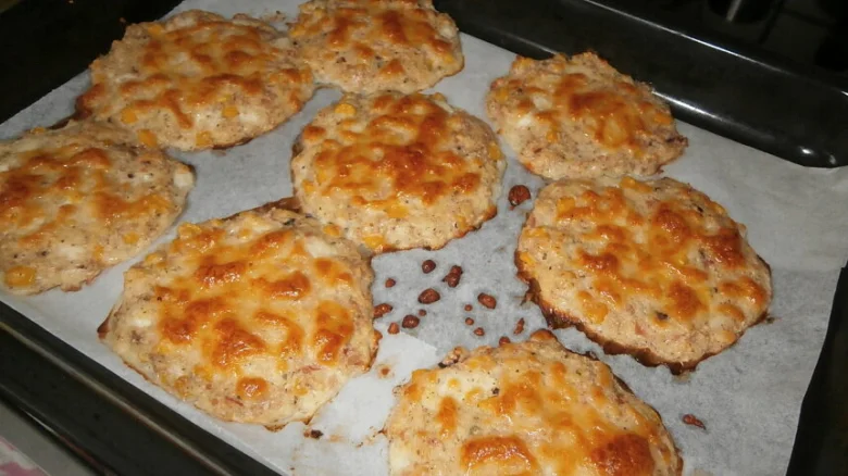 Zapečené placky z cottage s rozpuštěným sýrem na plechu.
