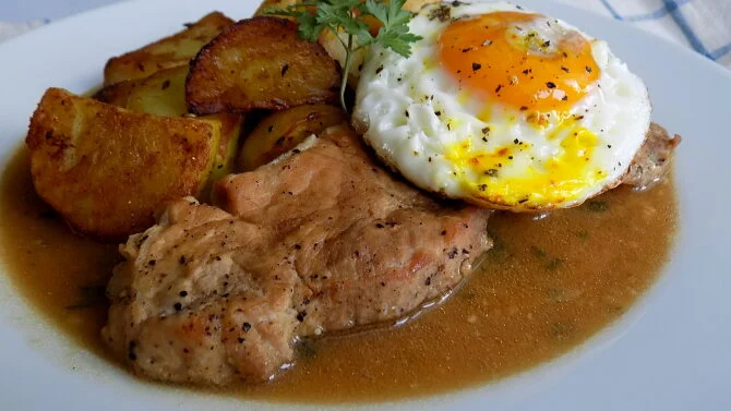 Pork chop with egg and potatoes