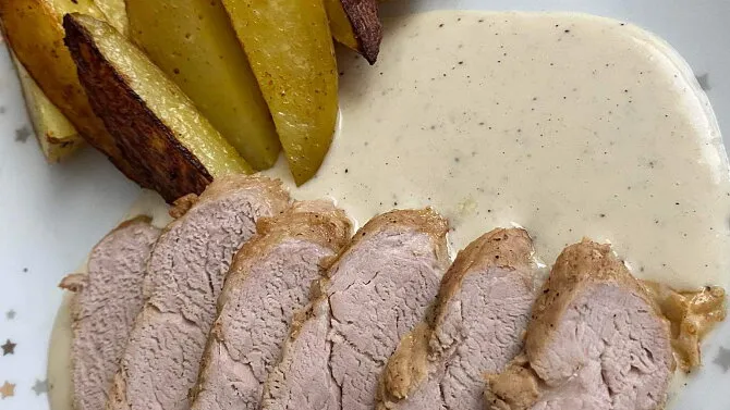 Sliced pork loin with sauce and fries