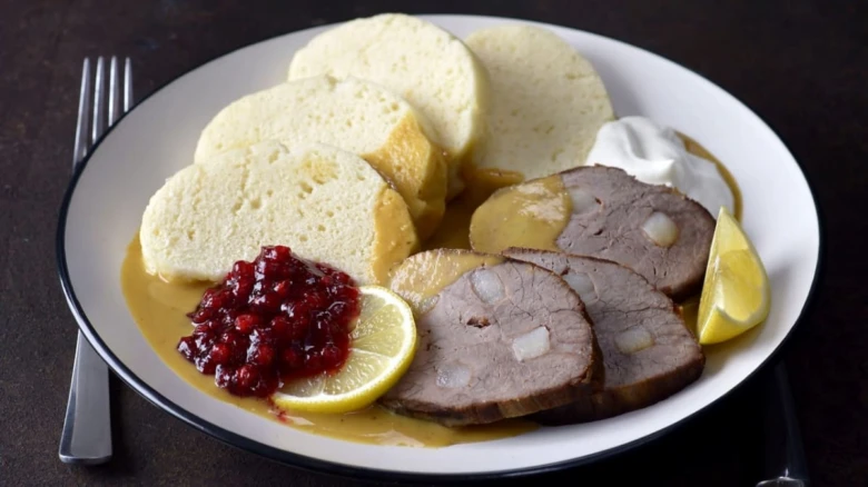 Přesýpané maso s omáčkou, knedlíkem a brusinkovou marmeládou.