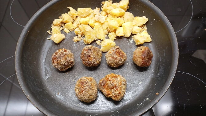 Meatballs and potatoes in pan