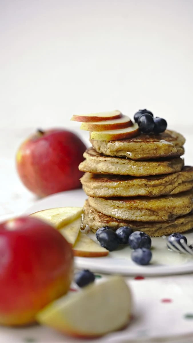 Stack of apple pancakes with fruit