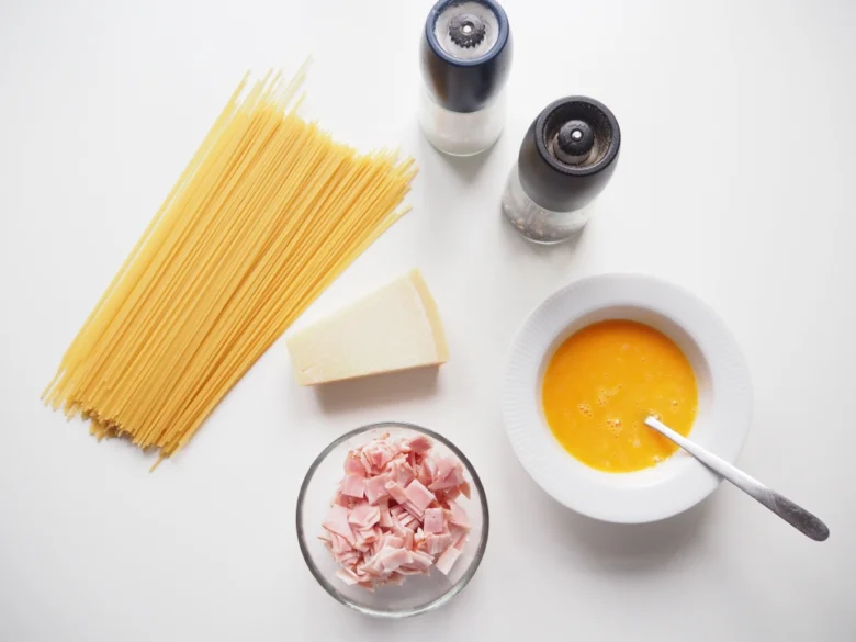 Suroviny na spagetti karbonáru: těsto, vejce, sýr, šunka.