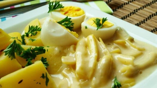 Boiled eggs and potatoes in sauce
