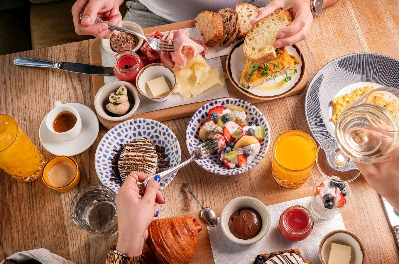 Breakfast spread with people eating
