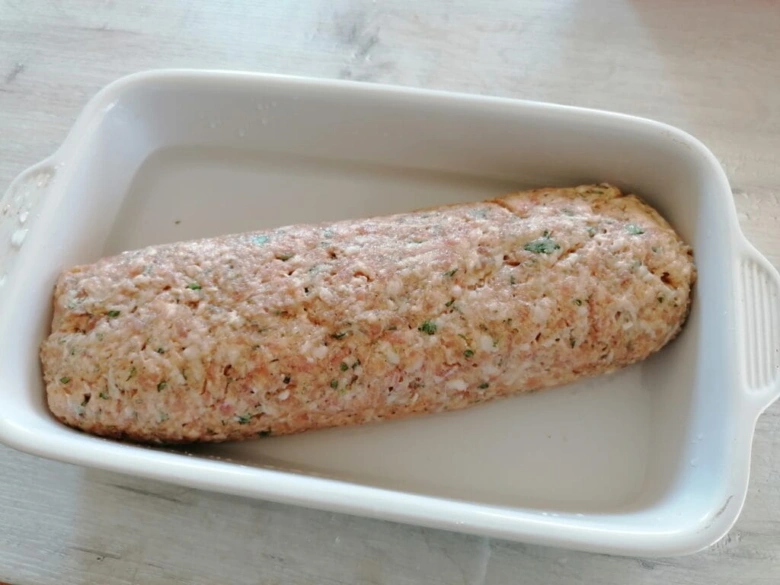 Raw meatloaf in dish