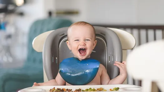 Happy baby eating lunch