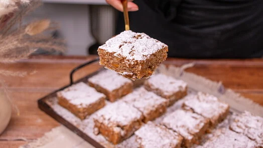 Carrot cake squares with nuts and powdered sugar