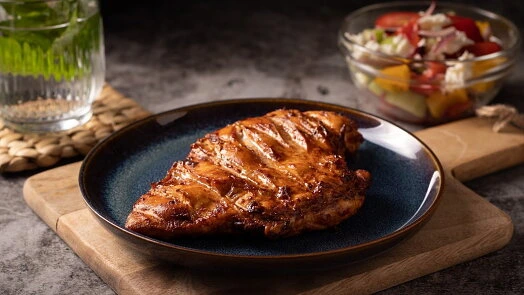 Grilled chicken breast with salad and drink