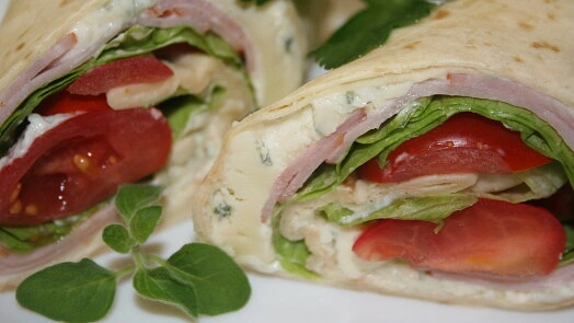 Stuffed tortilla wrap with ham and tomato