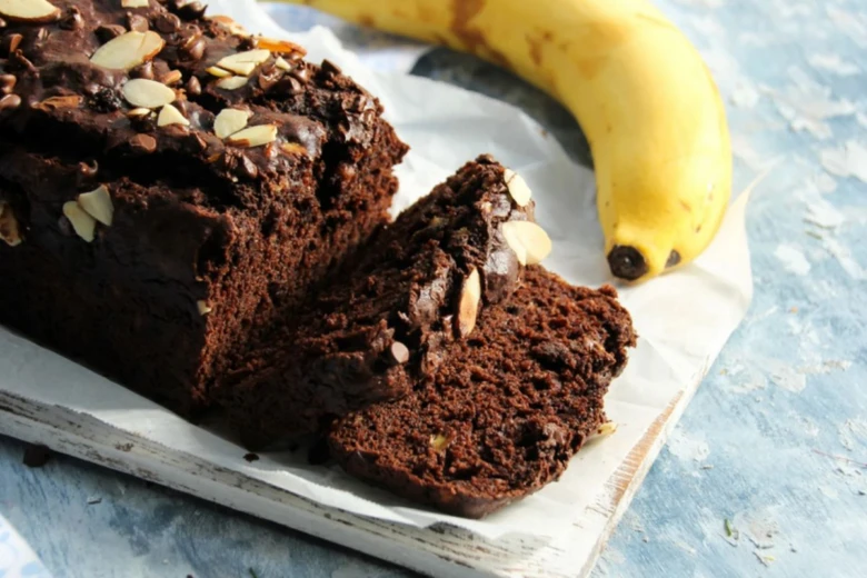 Banana bread loaf with slice and banana