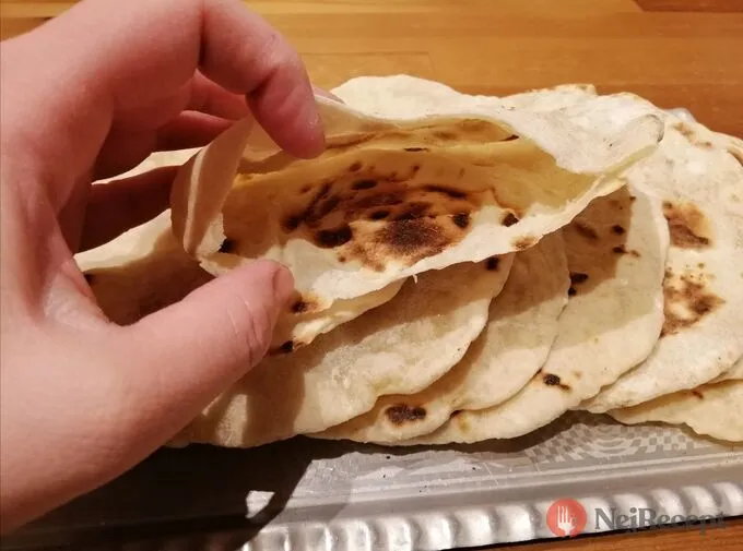 Hand holding flatbread stack