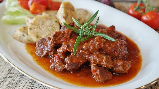 Beef stew with rosemary garnish